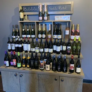 a large display of wine bottles