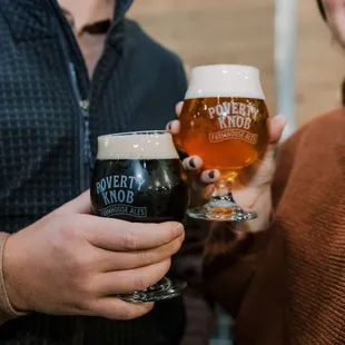 a man and a woman holding glasses of beer