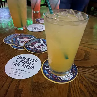 a glass of lemonade with a straw