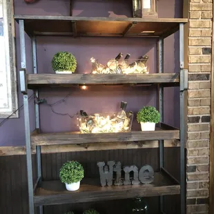 a display of wine bottles and plants