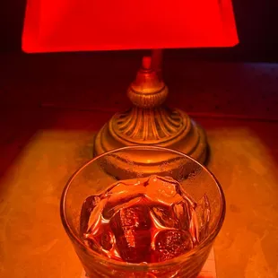 a glass of coke and a red lamp