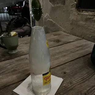 a bottle of water with a lime in it