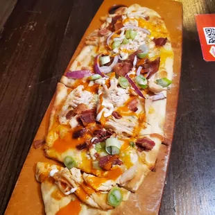 a flatbread pizza on a cutting board