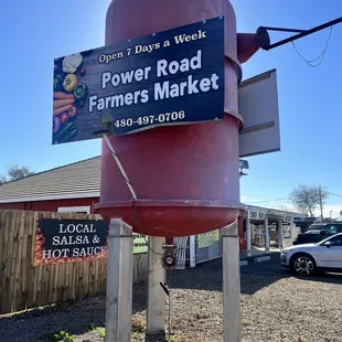 a sign for power road farmers market