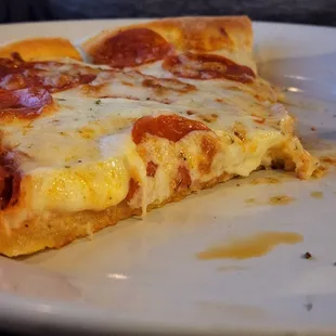 Pizza with half inch cheese, extra papperoni, and tosinos sauce