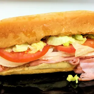 a sub sandwich on a black plate