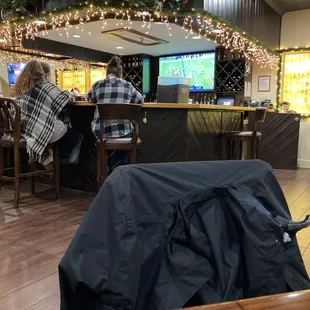 two people sitting at a bar