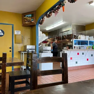 a kitchen with a counter and chairs