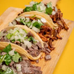 three tacos on a cutting board