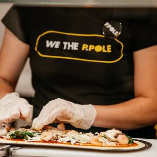 a person preparing a pizza