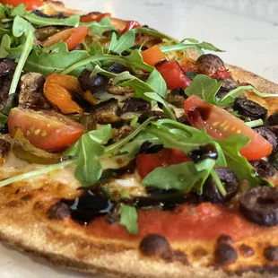 a pizza topped with vegetables