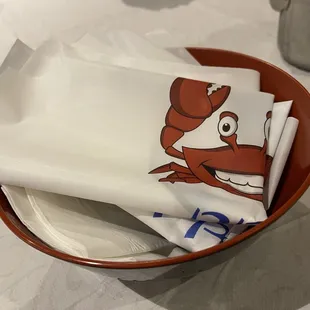 Plastic bibs place setting at PPQ Dungeness Island in San Francisco.