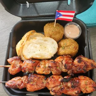 chicken skewers with bread and dipping sauce