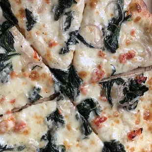 PIZZA FLORENTINE (white pizza with roasted garlic, fresh spinach, sun dried tomatoes, shallots, mozzarella, and parmesan)