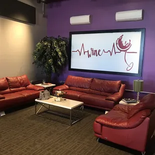lounge area with red leather furniture