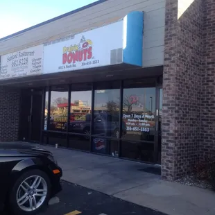 a car parked in front of a donut shop