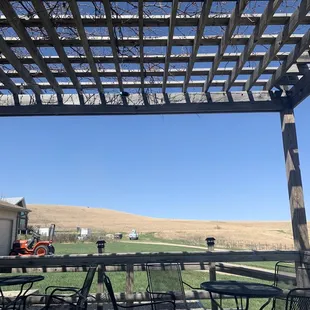 a patio with tables and chairs