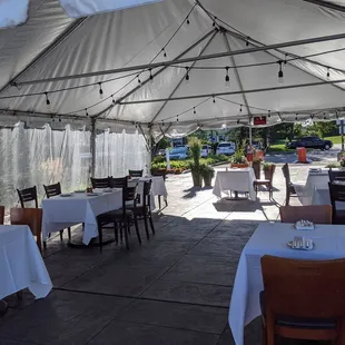 tables and chairs under a tent