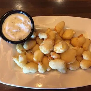 a plate of potatoes and dip