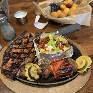 10oz ny strip with loaded baked potato and veggie skewer.