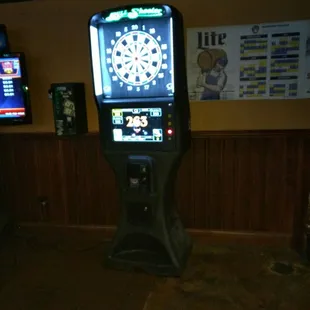 a dart and dartboard in a game room