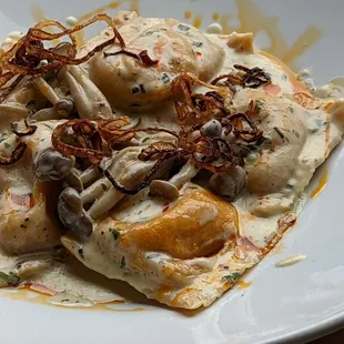 Butternut Squash Ravioli |  fried shallots * red chile candied pecans * sautéed mushrooms * herb cream sauce