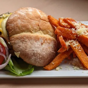 Local Bison Burger |  potato bun * roasted garlic aioli * lettuce * tomato * onion * Tillamook  cheddar * truffle sweet potato fries