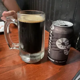 a beer and a can on a table