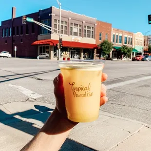 a hand holding a cup of coffee