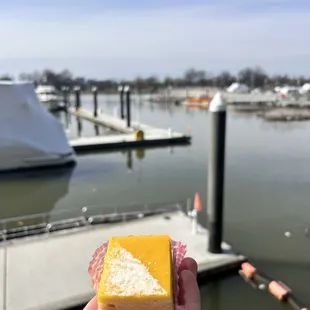 a hand holding a piece of pastry