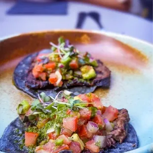 two tacos on a plate on a table