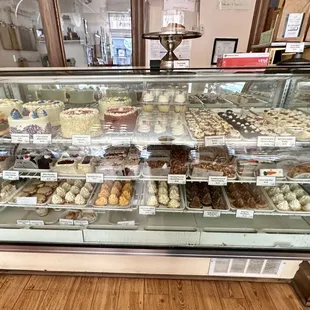 Display case of cakes, cupcakes, and pastries