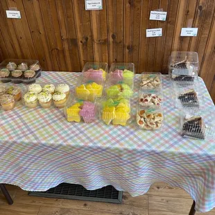 a table of cupcakes and pastries