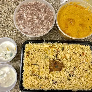 a tray of rice and bowls of soup