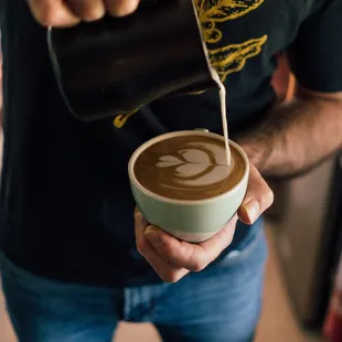a man pouring coffee into a cup