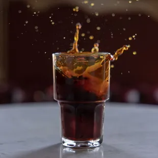 a drink being poured into a glass
