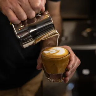 a man pouring a cup of coffee