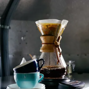 a coffee pot and a cup of coffee