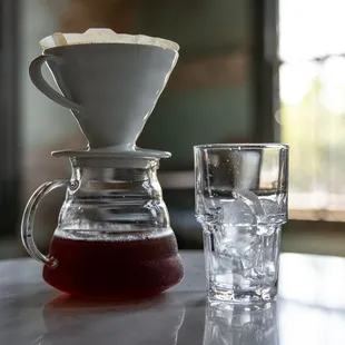 a glass of water and a pourer