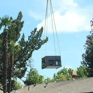 a house being lifted by a crane