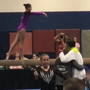 Coaches Debbie and Bill hugging after Laurel had stuck her toughest maneuver on the beam securing the State Championship in All Around!