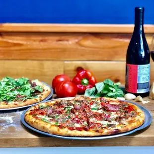 two pizzas and a bottle of wine