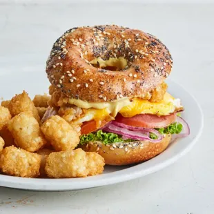 a bagel sandwich and tater tots