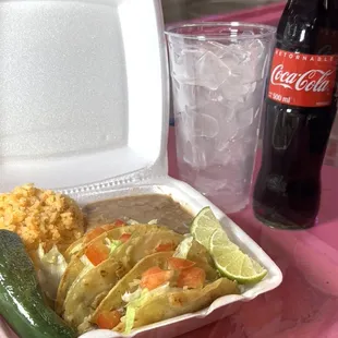 3 small quesadillas on corn in a plate with rice and refried beans.