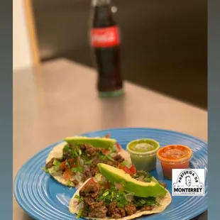 Fajita tacos on corn tortilla with pico and avocado slices.