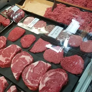 a variety of meats in a display case