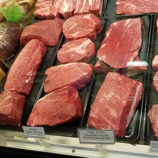 a variety of meats in a display case