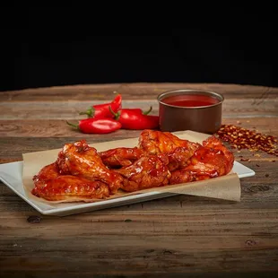 a plate of chicken wings and sauce