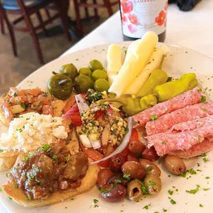 a plate of appetizers and a bottle of wine