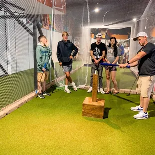 Hitting the golf ball through the net to get to the hole!